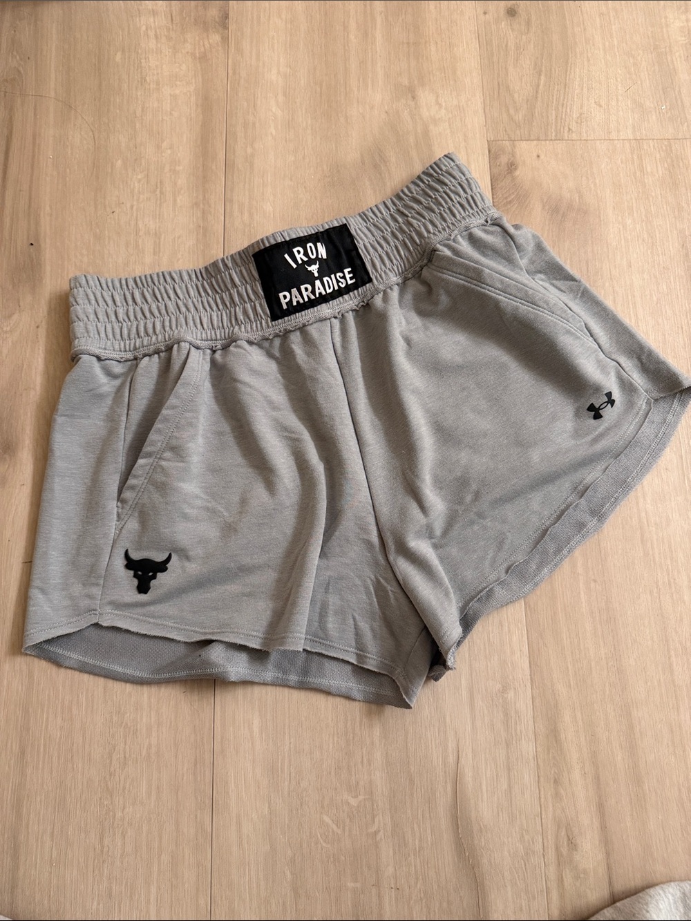 Under Armour Women's Light Gray Athletic Shorts with Iron Paradise Patch